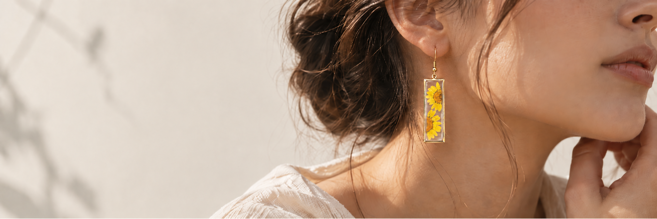 Model wearing NatureLuxe yellow pressed-flower earrings
