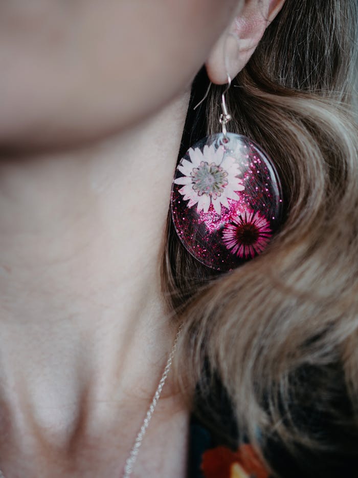 Elegant close-up of handmade floral resin earring in artistic photography.