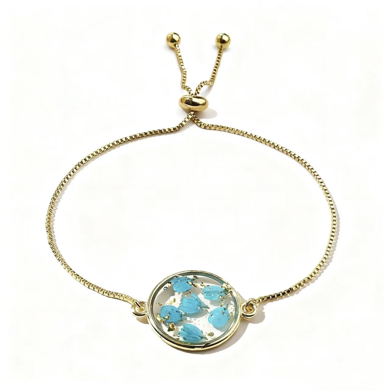 gold adjustable bracelet with blue pressed flower charm gold adjustable bracelet with blue pressed flower charm