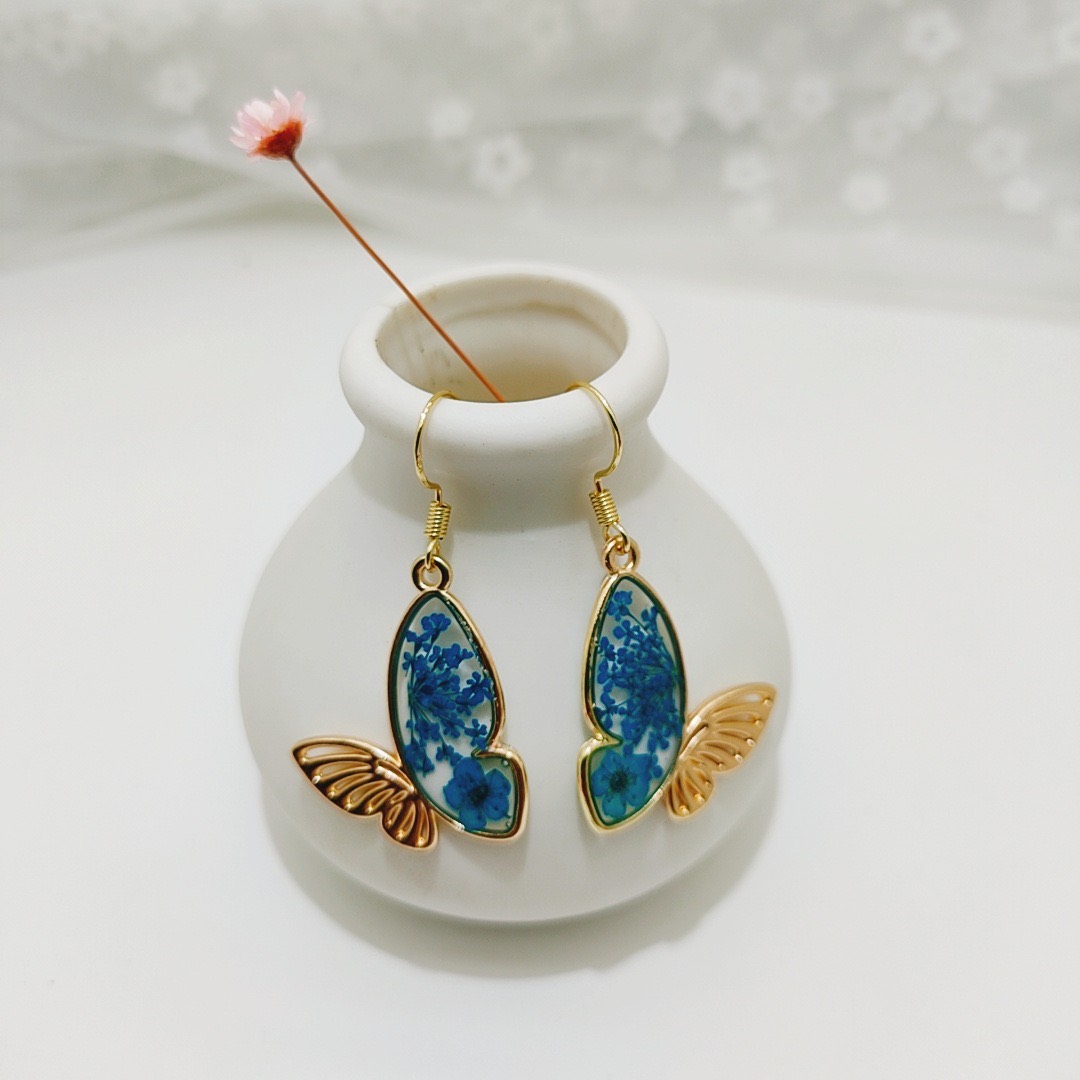 Blue pressed flower butterfly drop earrings